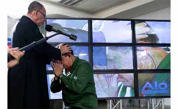 Hugo Chavez Blessed by a Priest 01